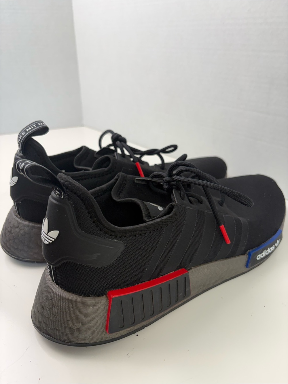 Adidas NMD_R1 Black Sneakers with Red and Blue Accents